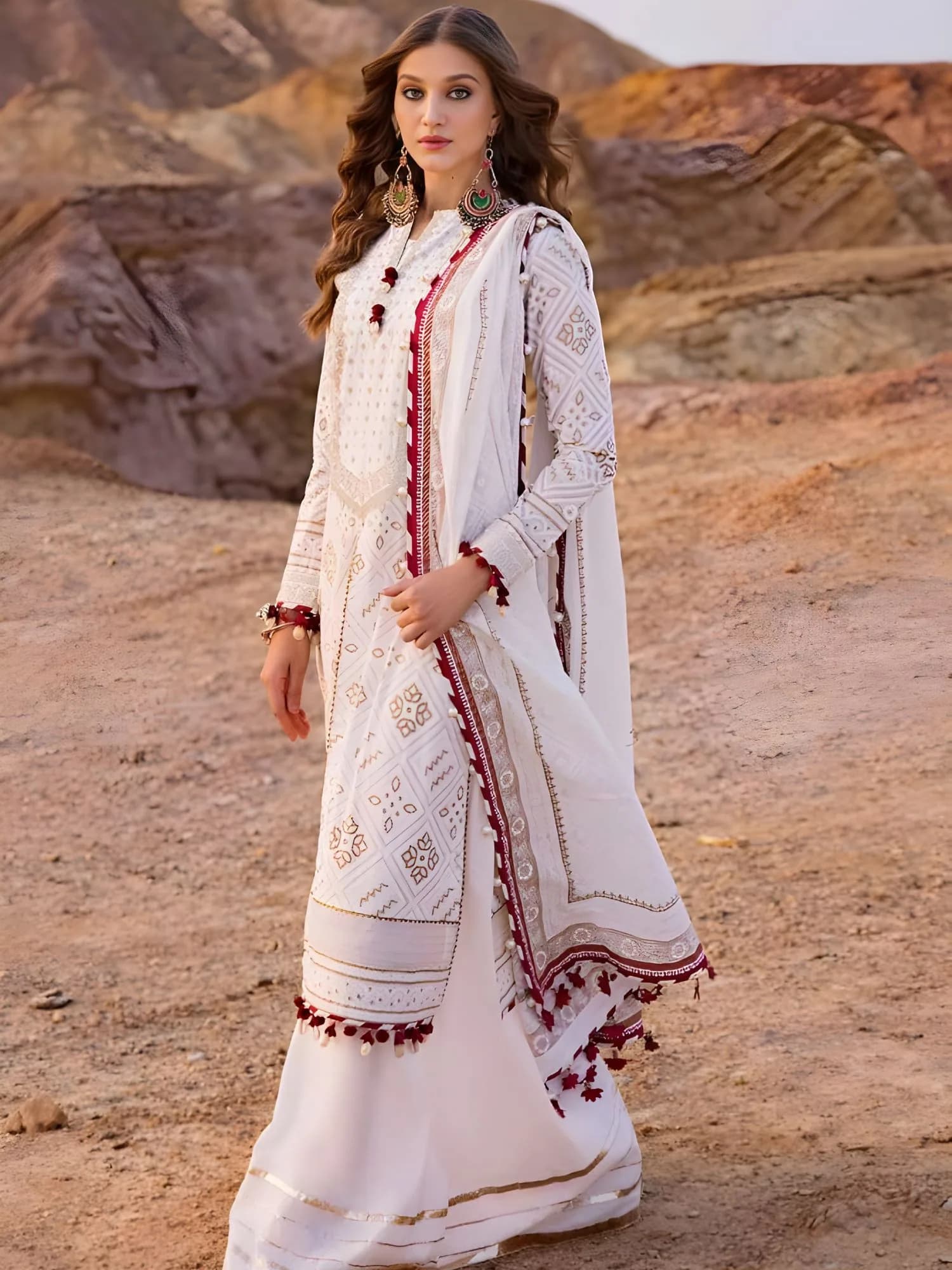 Model wearing off-white Gul Ahmed suit with wide-leg trousers and maroon trimmed dupatta