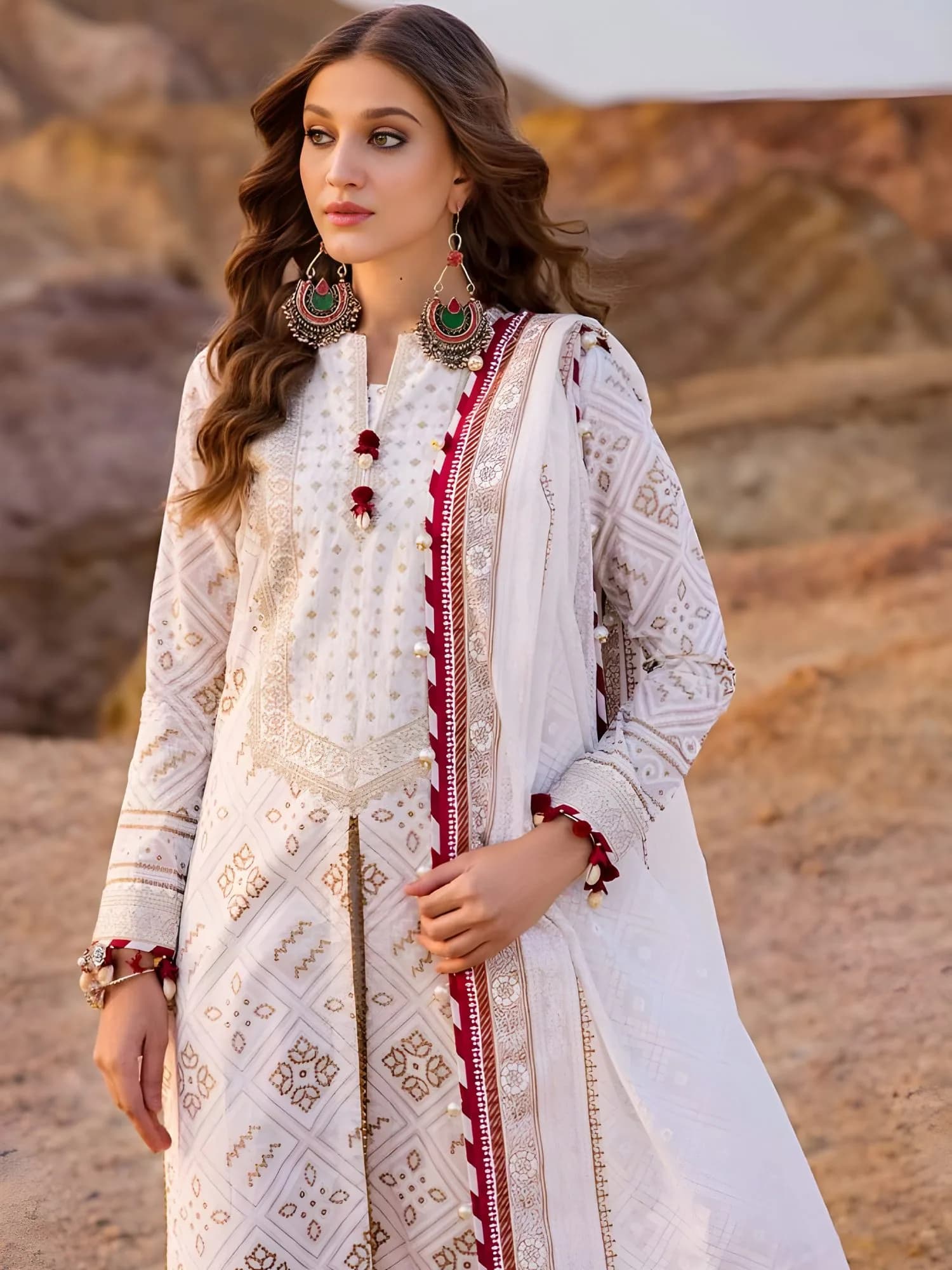 Close-up of embroidered neckline and sleeves border with gold print detailing on lawn fabric