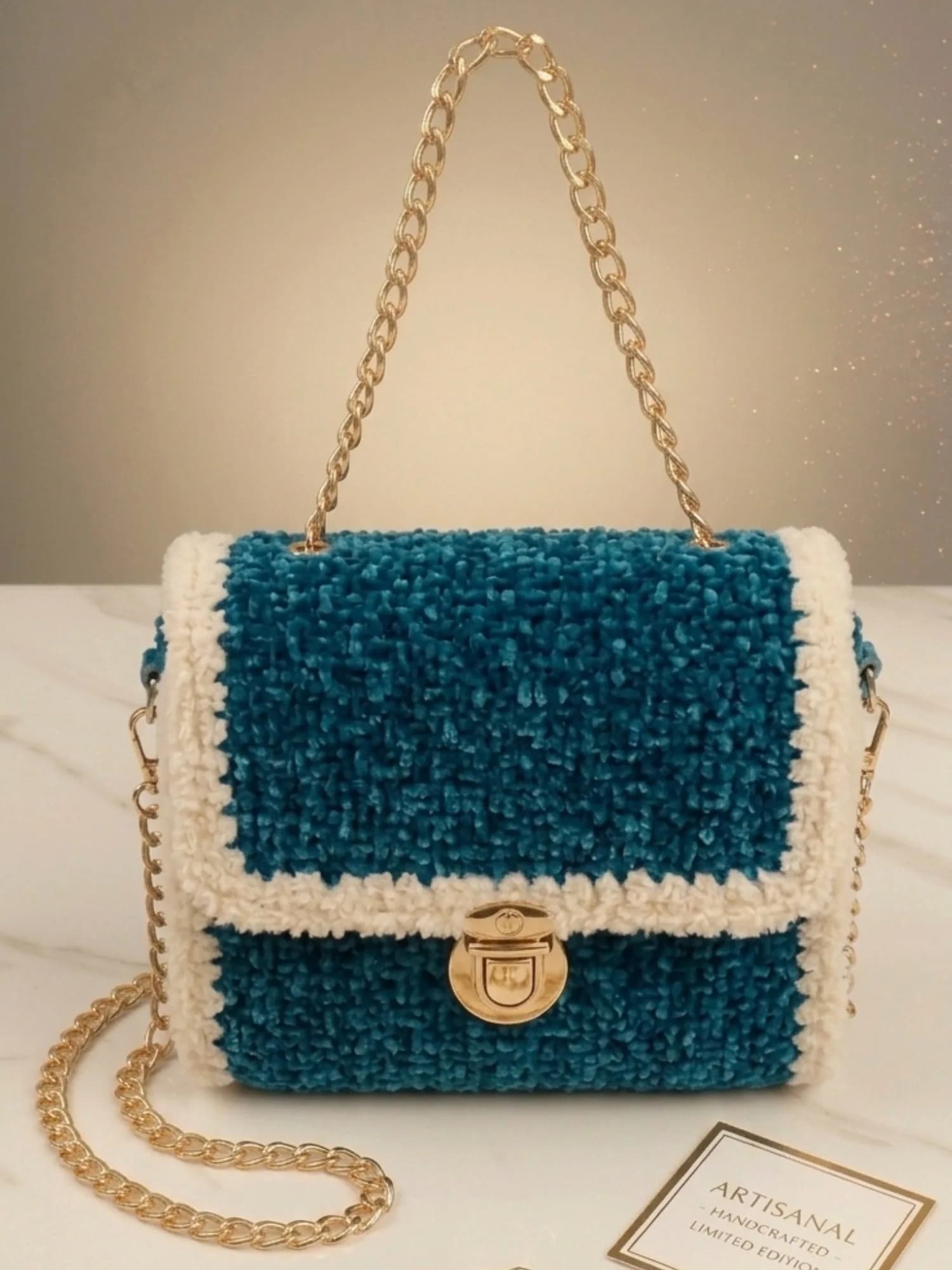 Teal crochet crossbody bag with gold chain strap and gold-tone flap lock